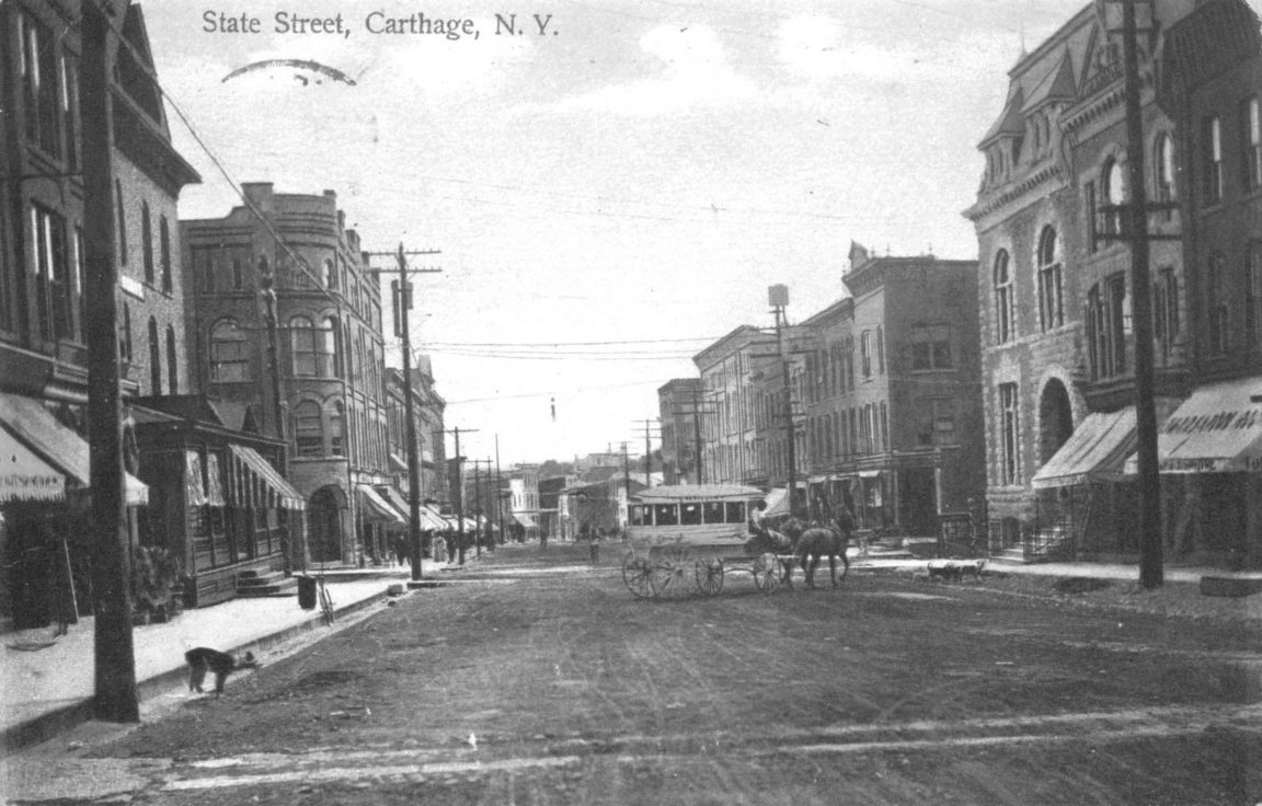 A horse-drawn stagecoach transports passengers on State Street in ...