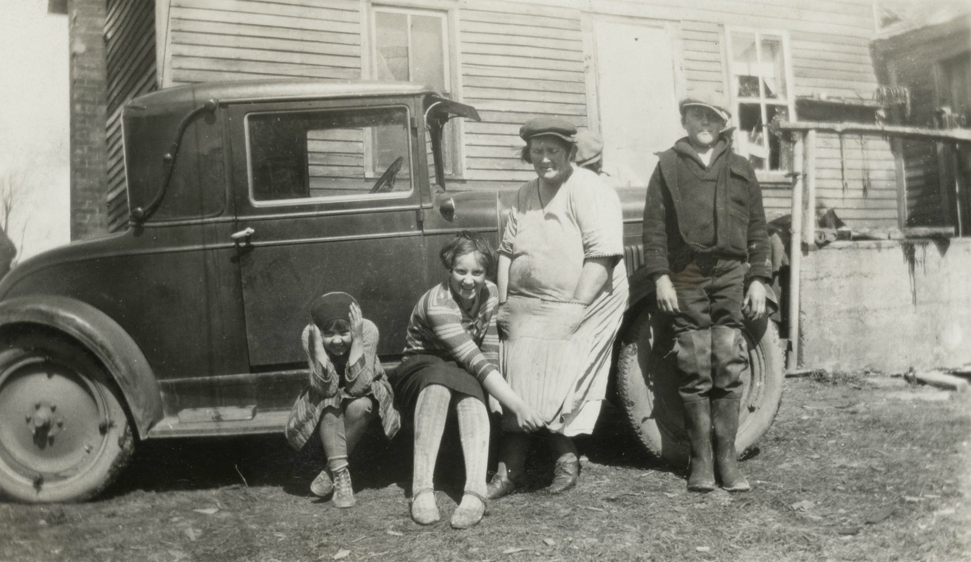 The Rockwood family in front of an automobile on their farm in Pillar ...