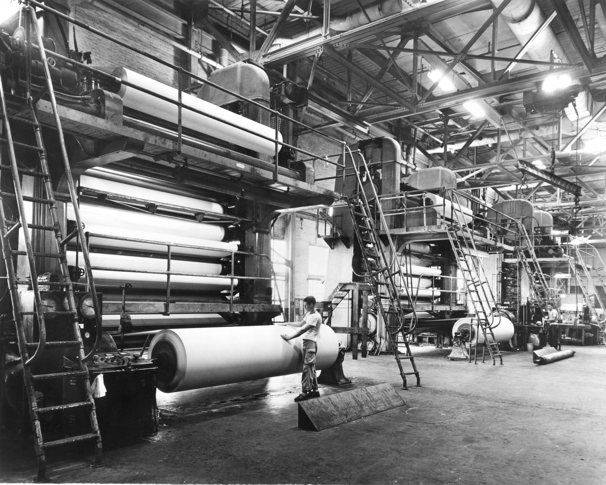 Worker at a super calendar machine at the St. Regis Paper Company mill