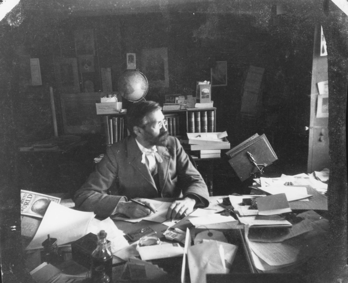 Seneca Ray Stoddard at his desk in Glens Falls