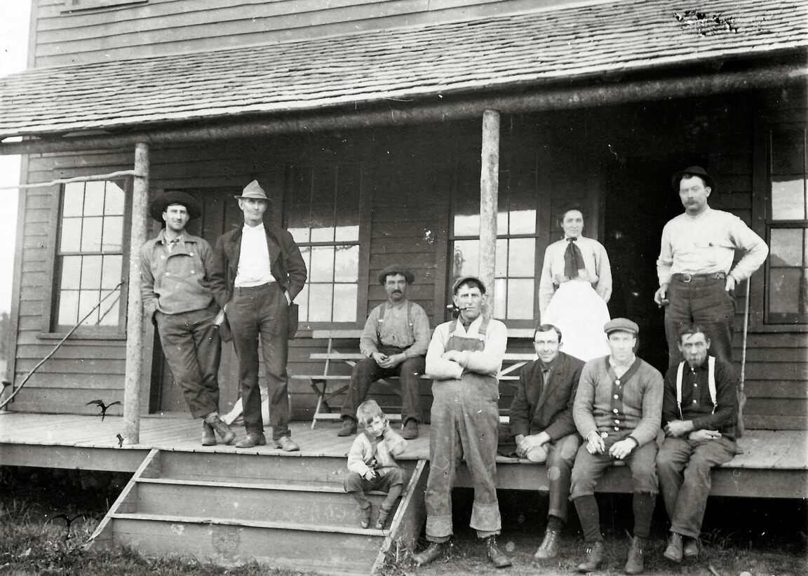 Wildnerness guides on the steps of a guide house in Beaver River